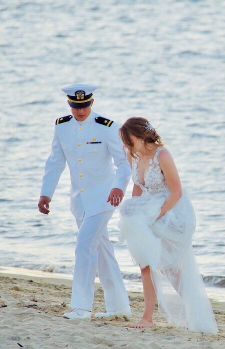 beautiful-scene-of-a-navy-man-in-uniform-walking-with-his-bride-on-the-sand-by-the-seashore_t20_bxNXXm-e1605139993462.jpg