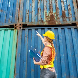 Female logistic worker checking container at site
