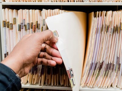 Medical records, charts, African American man sorting through patient charts